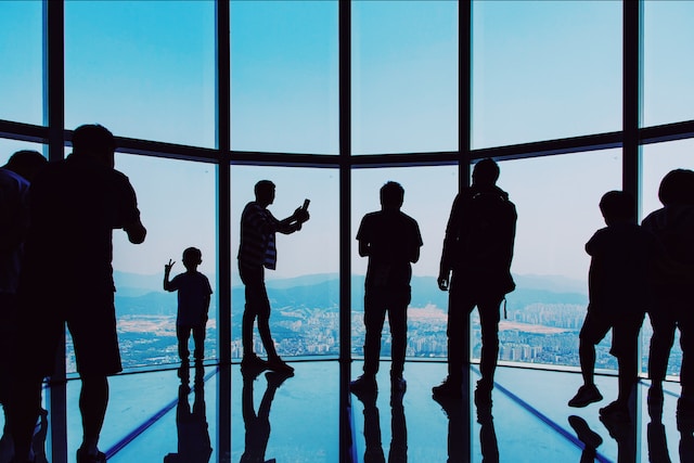 people in high-rise building taking photos in Korea in one of the tourist attraction buildings